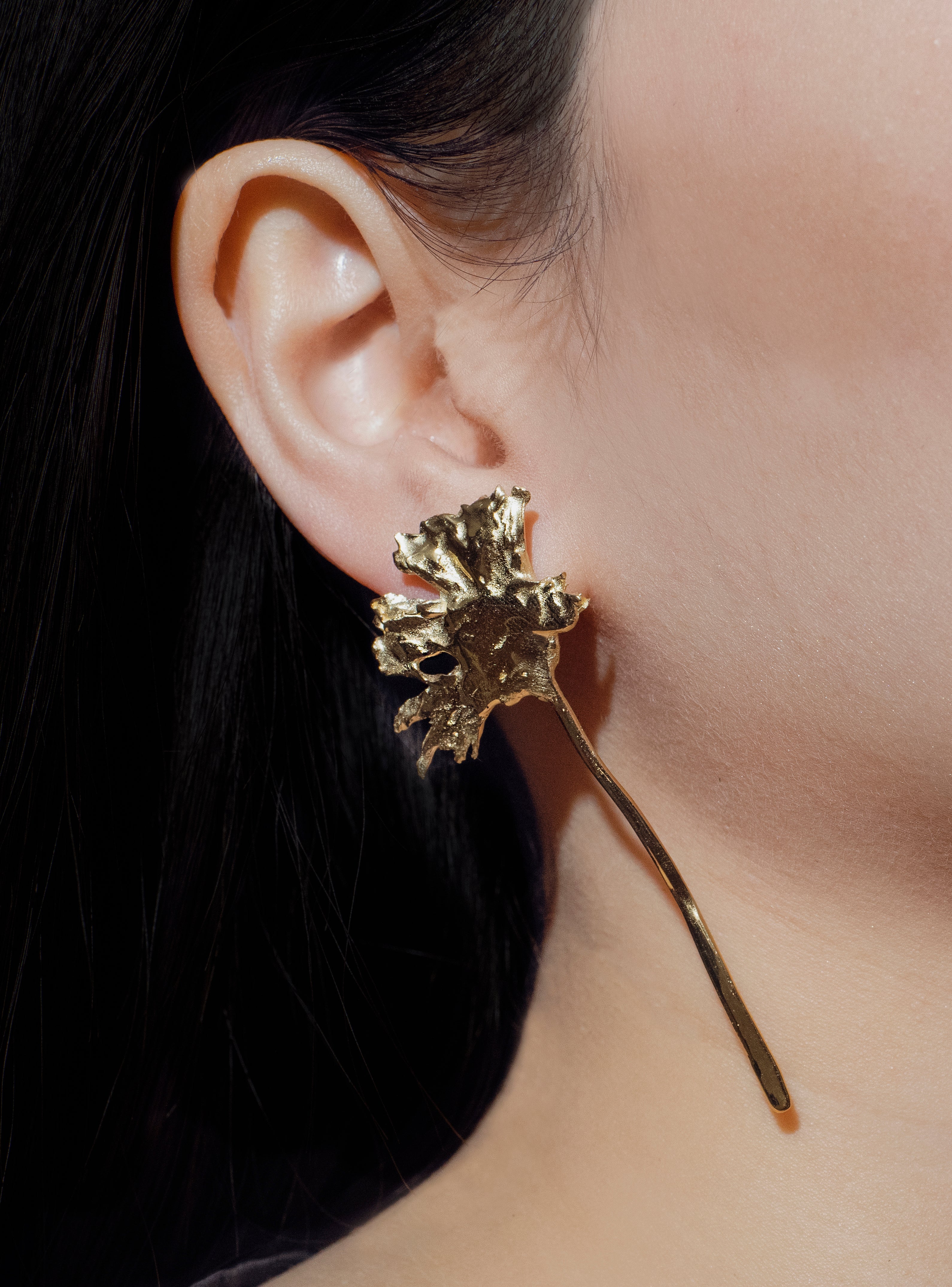 handcrafted gold daisy earring left ear