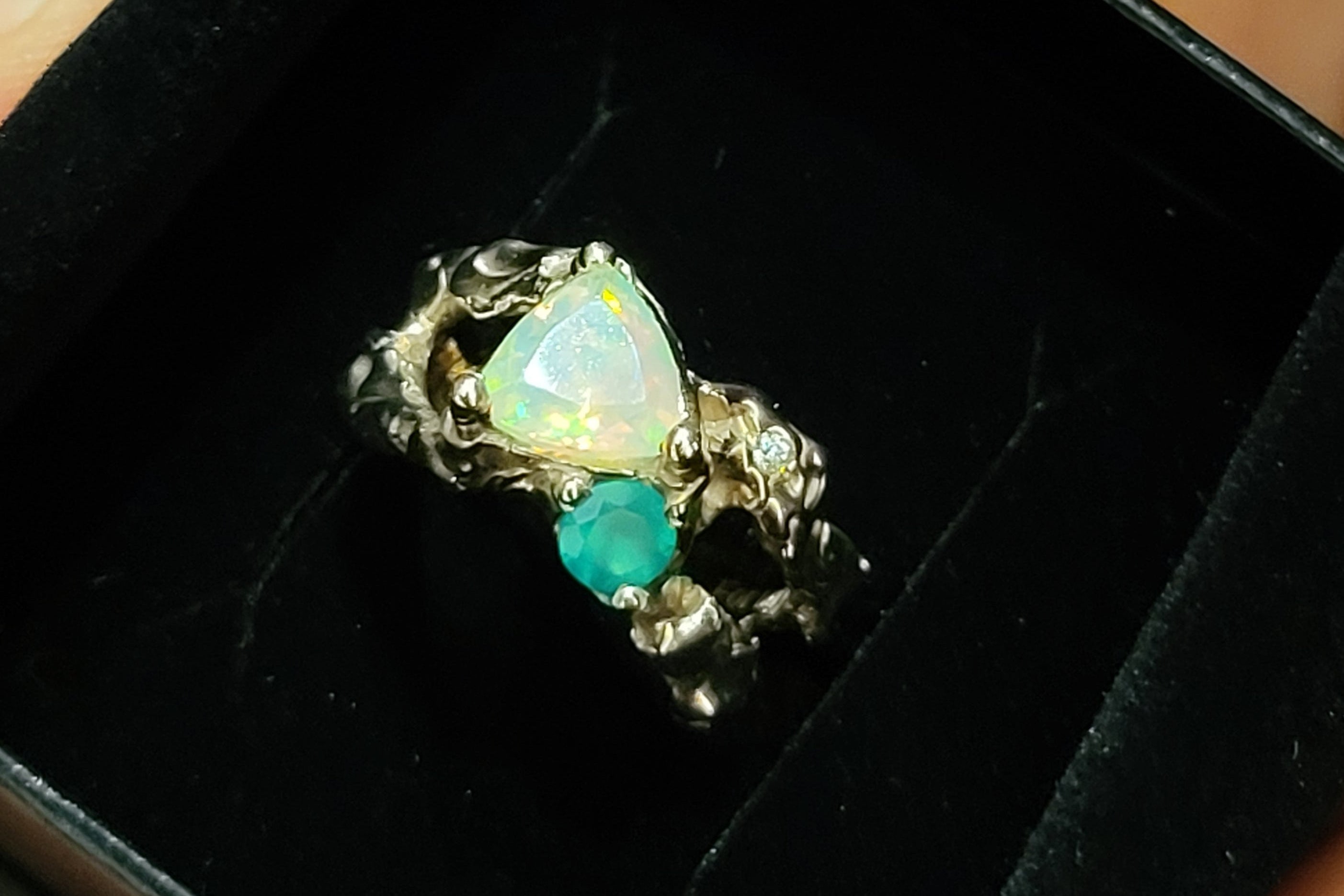 handcrafted gold engagement Ring with a central opal stone in a black box