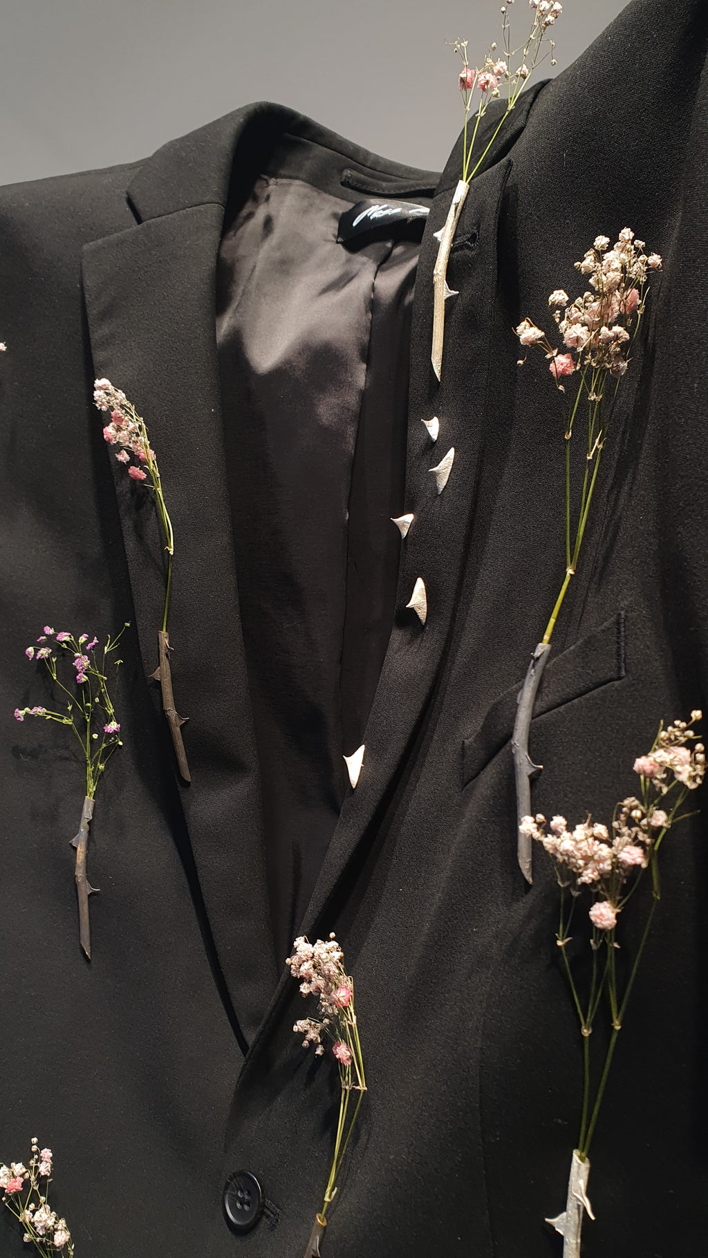 Handcrafted Brooches onn a black coat 