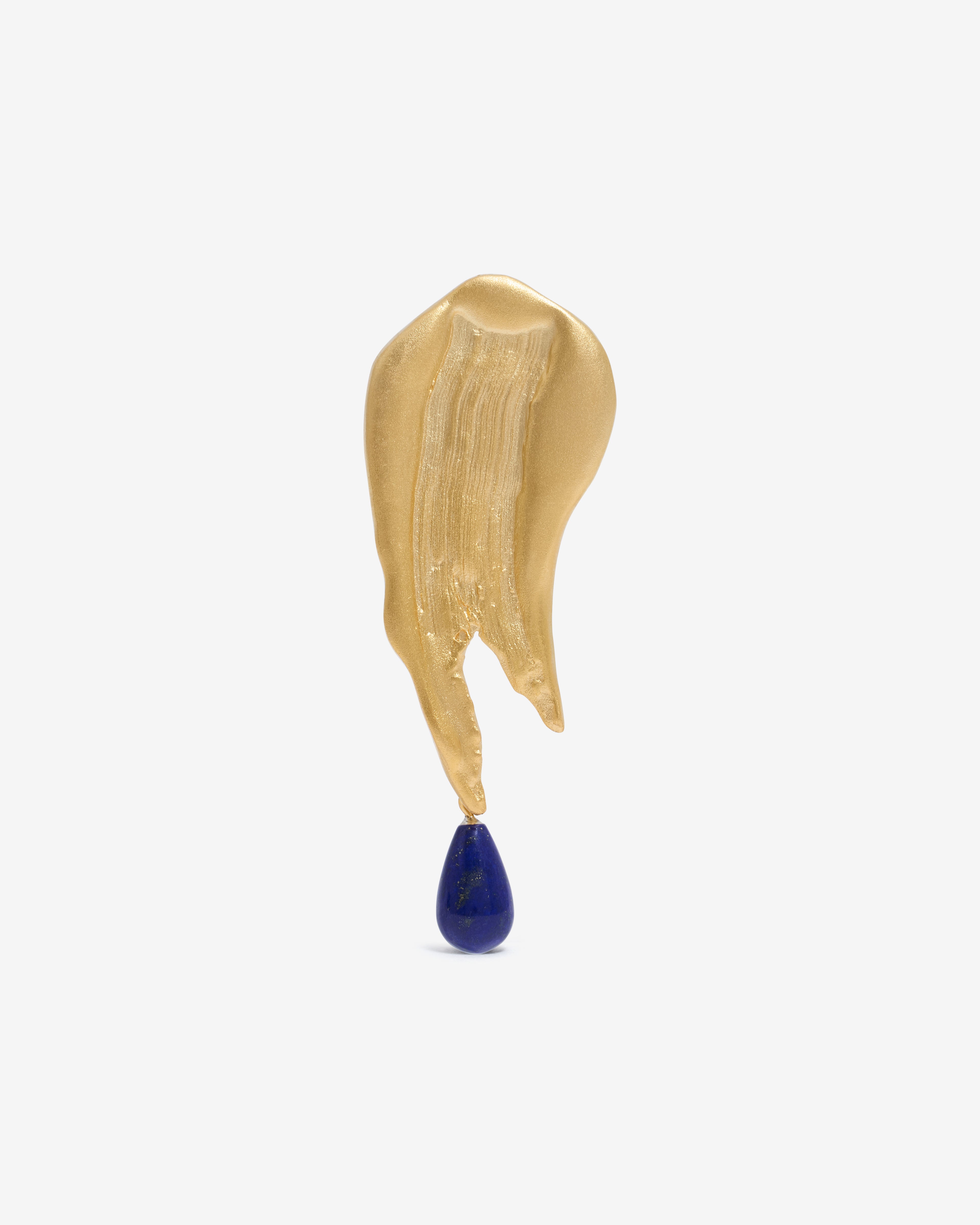 Handcrfated gold brooch with a blue gemstone hanging from the bottom on a white background