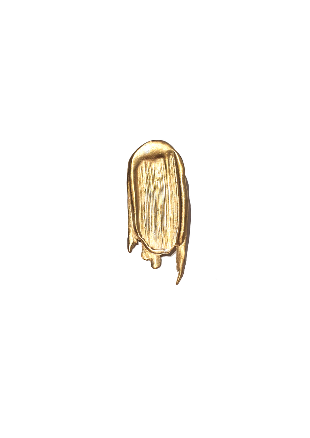 Handcrafted gold brooch looking like a paint stroke on white background