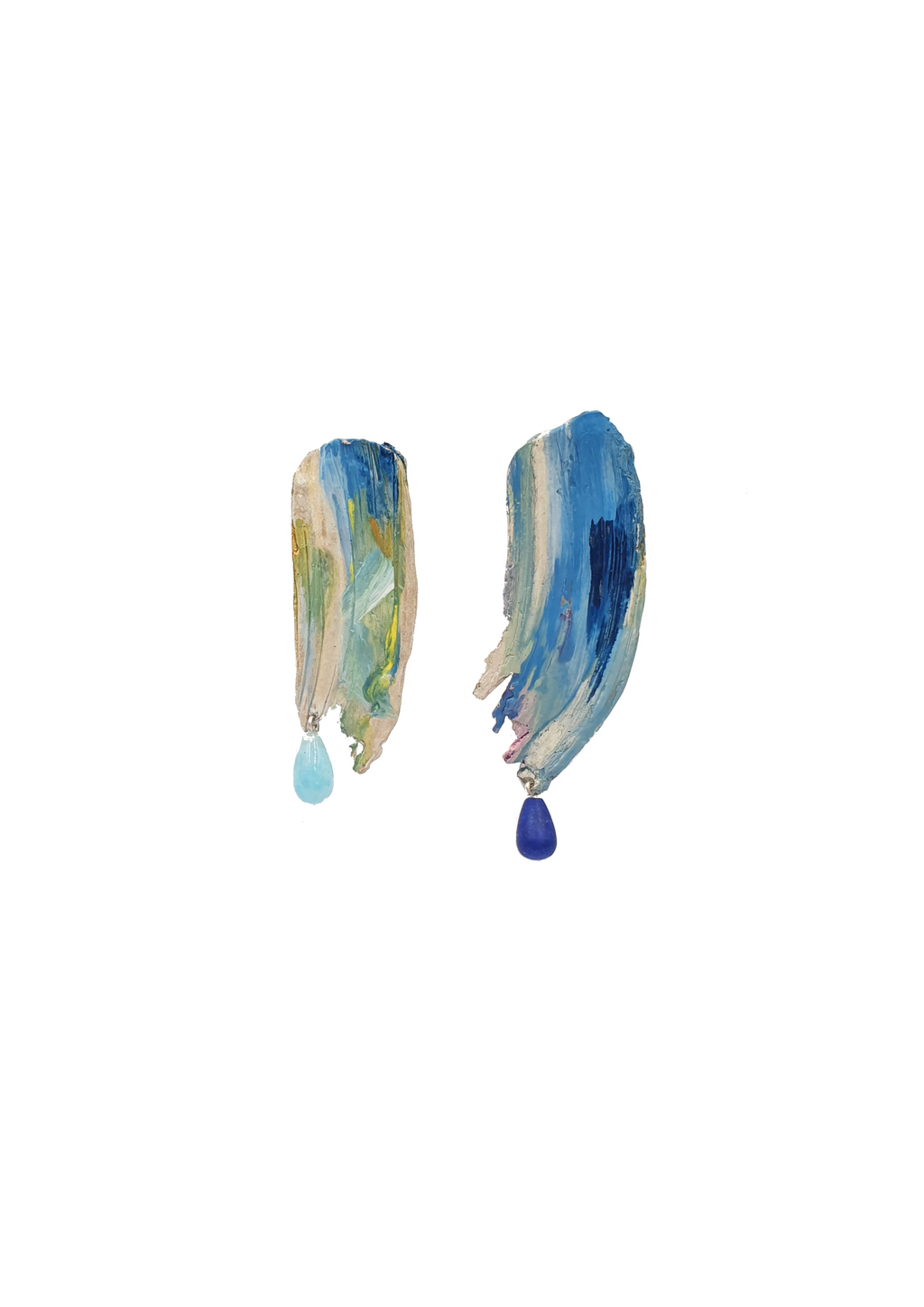 Handcrafted earrings with blue enamel on top, attached to the bottom are two gemstones, one light blue and dark blue