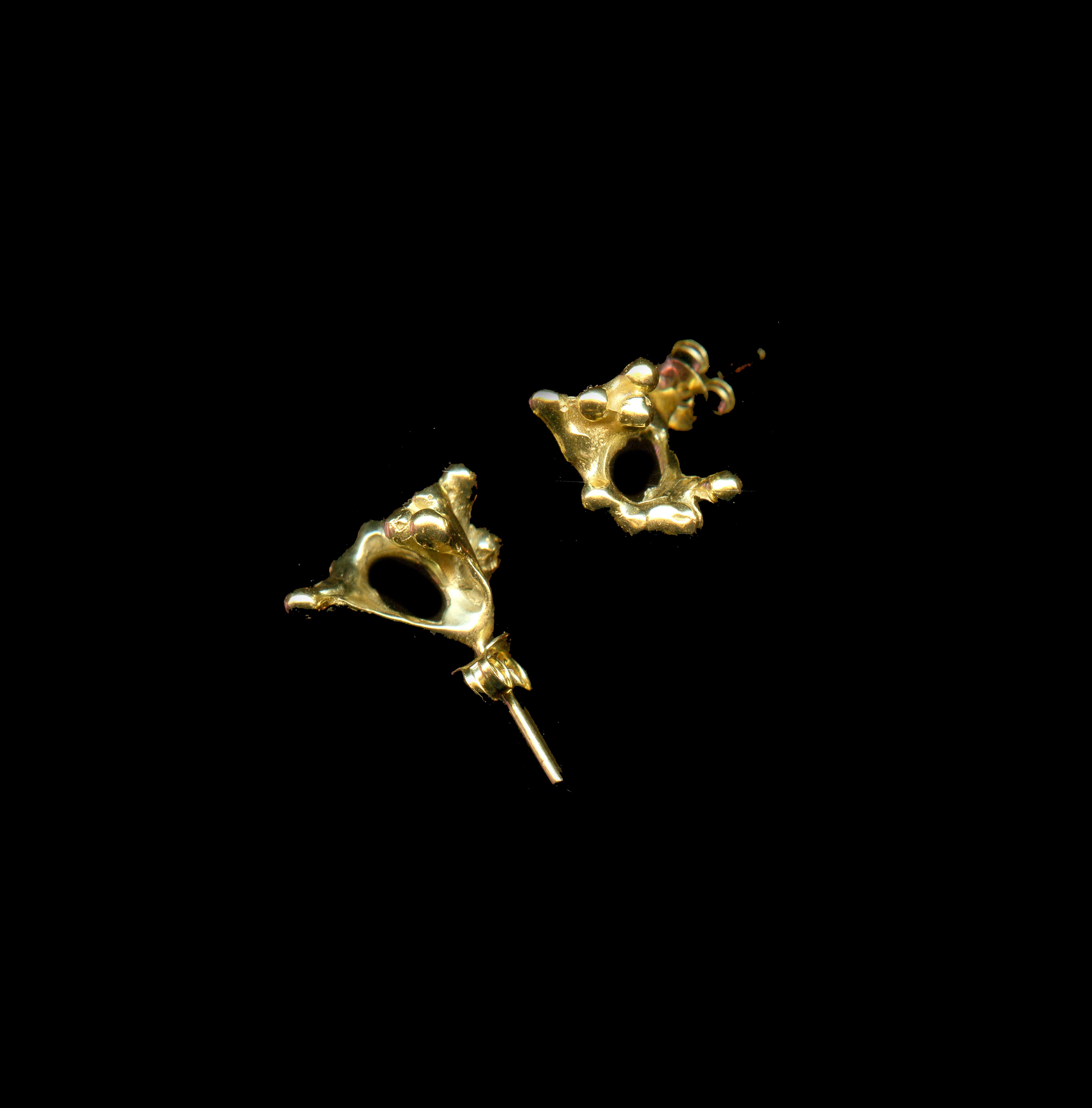 handcrafted gold rubella ring on black background