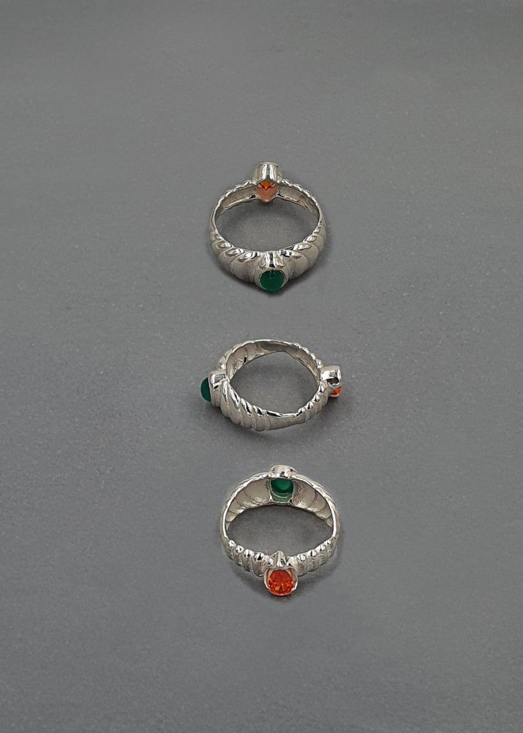handcrafted silver rings on grey background