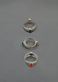 handcrafted silver rings on grey background