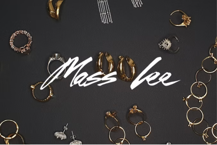 handcrafted Gold jewelry pieces on a black background with 'Mass Lee' branding.