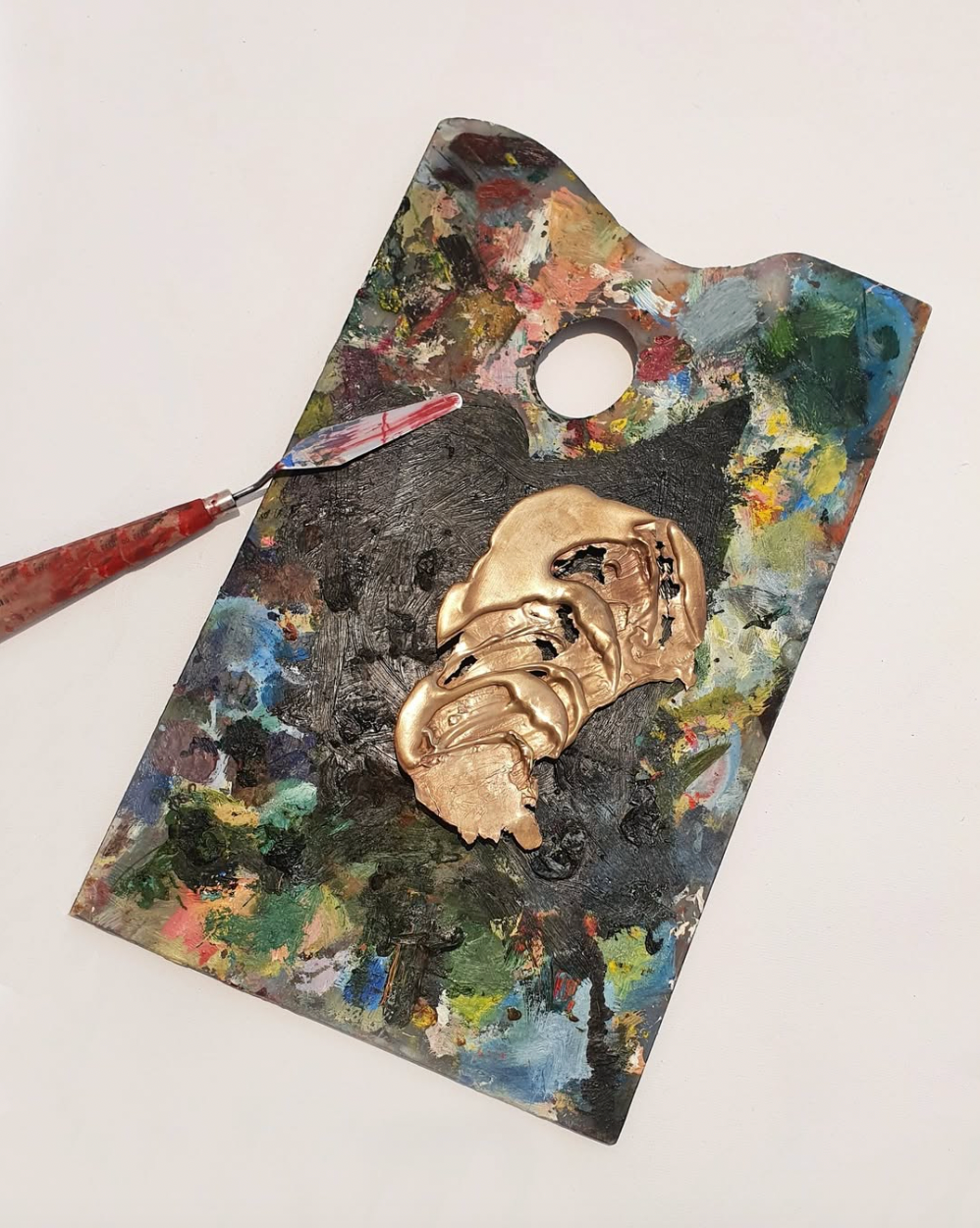 paint palette from the top with gold paint on it